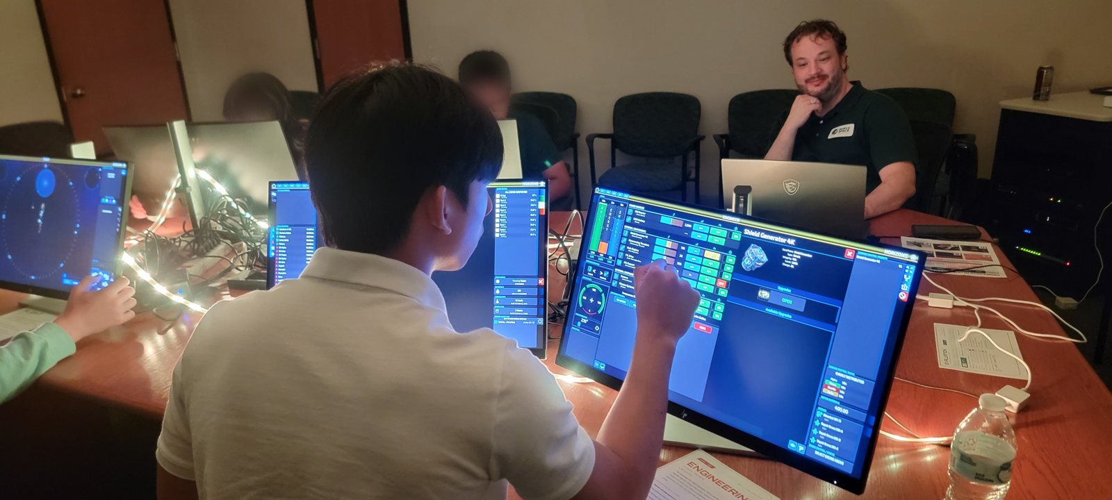 Student at the Engineering station reacting to a mission event on the starship bridge
